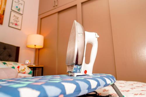 a sewing machine sitting on top of a bed at Calm House near Enchanted Kingdom Sta Rosa with Free Parking, Wifi, Netflix in Santa Rosa