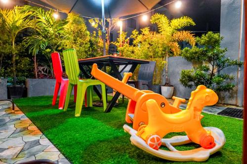 a playground with colorful chairs and a table at Calm House near Enchanted Kingdom Sta Rosa with Free Parking, Wifi, Netflix in Santa Rosa