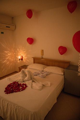 a bedroom with a bed with red hearts on the wall at Hotel los leones Melgar in Melgar