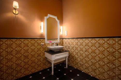 a bathroom with a sink and a mirror at Ayr Castle 1922 by Reveal in Padukka