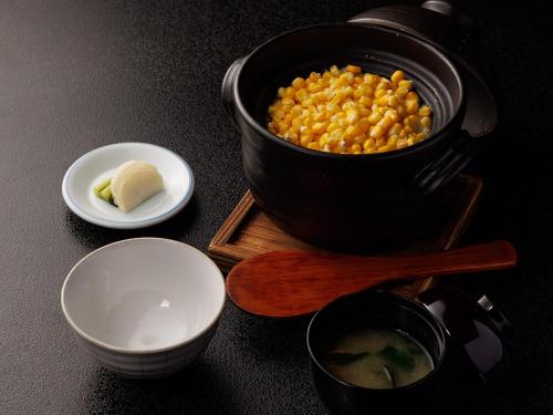 a pot of corn and a bowl of butter on a table at Chousenkaku Kameya in Shimo-suwa