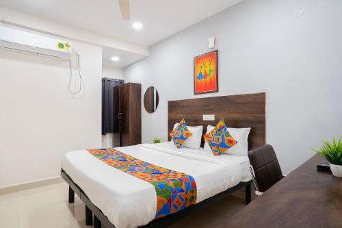 LingampalliFabExpress Grand Aarvi Prime - Nr GSM Mall, Madeenaguda的带一张大床和一张桌子的卧室
