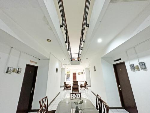 a dining room with a glass table and chairs at Casa Feby Guest House in Bandung