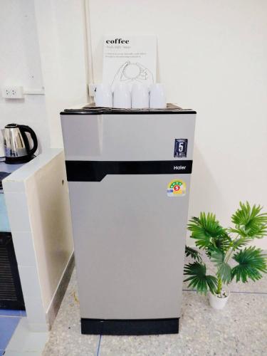 a small refrigerator with a box on top of it at D72 Family House, 8PAX 3BR Hat Yai Middle Town in Hat Yai