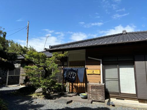 a house with a towel hanging on the side of it at 島の宿 近 〜KON〜 in Oshima