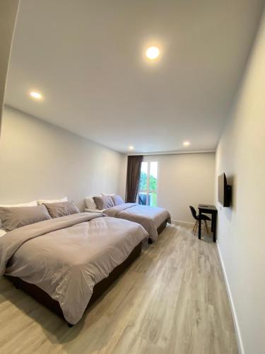 a bedroom with two beds and a window at Cozii Home Marang in Marang