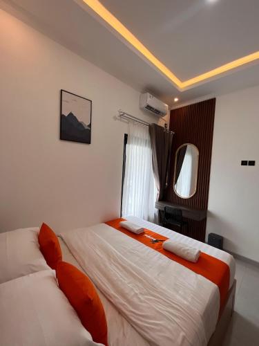 a bedroom with two beds and a window at Hai Homestay by Sampai Coliving in Medari