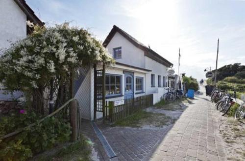 a white house with bikes parked outside of it at Buhne 11 in Vitte