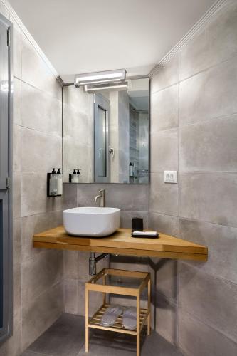 a bathroom with a sink and a mirror at Mont D' Olives in Mythimna
