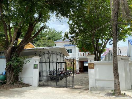 a gate with a group of motorcycles parked behind it at Muni Residence & Spa in Battambang