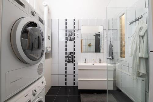 a bathroom with a sink and a washing machine at D17 Apartment in Budapest
