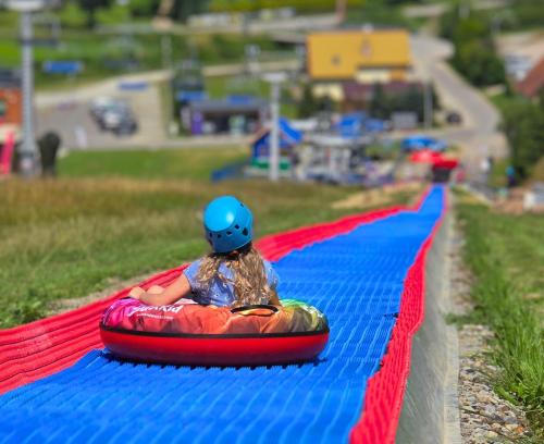 a young girl is riding on a ride on a inflatable at Hotel BIESZCZADski Wańkowa in Wańkowa