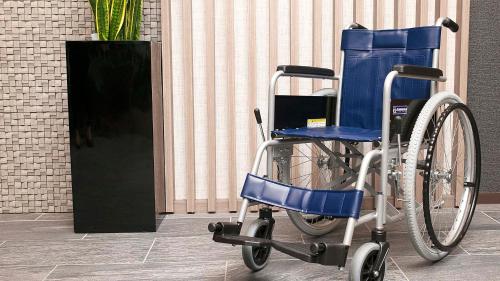 a blue wheelchair parked in front of a building at Hotel Route-Inn Susono Inter in Susono