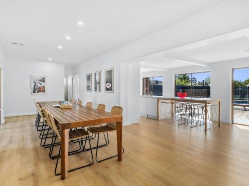 a dining room with a wooden table and chairs at Retreat House in Yarrawonga