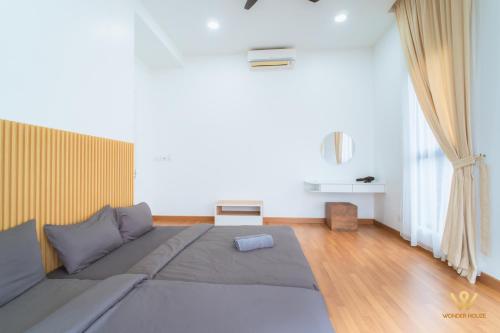 a living room with a large bed and a couch at Bandar Puteri Puchong Cozy Staycation at Le Pavilion - near SetiaWalk in Puchong