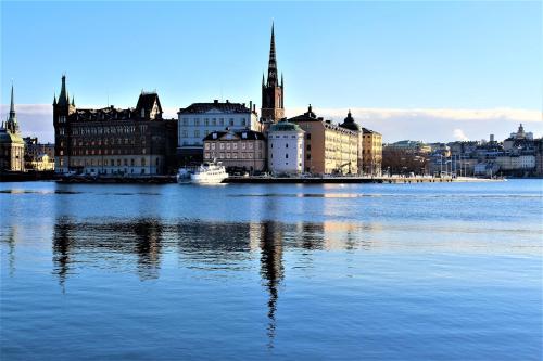 a view of a city from the water at Central apartment 5min drive to the Airport. in Stockholm