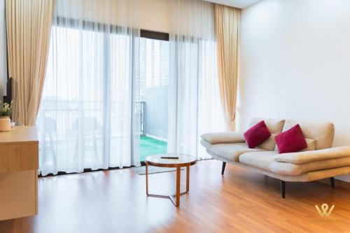 a living room with a couch and a large window at Bandar Puteri Puchong Cozy Staycation at Le Pavilion - near SetiaWalk in Puchong