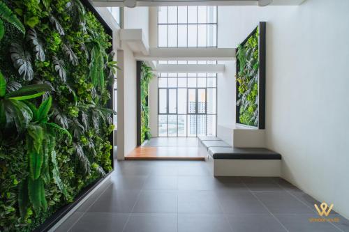 an indoor plant wall in a room with a bench at Bandar Puteri Puchong Cozy Staycation at Le Pavilion - near SetiaWalk in Puchong