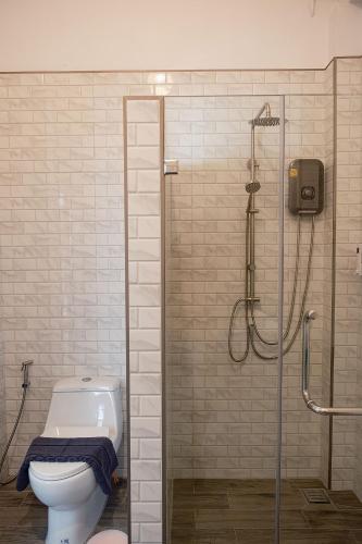 a bathroom with a shower and a toilet with a glass shower at KaiBaeBeach GrandView in Trat
