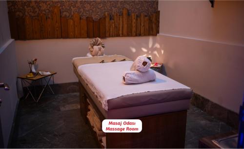 a bedroom with two stuffed animals sitting on a bed at Yalova Lova Hotel & SPA Yalova in Yalova