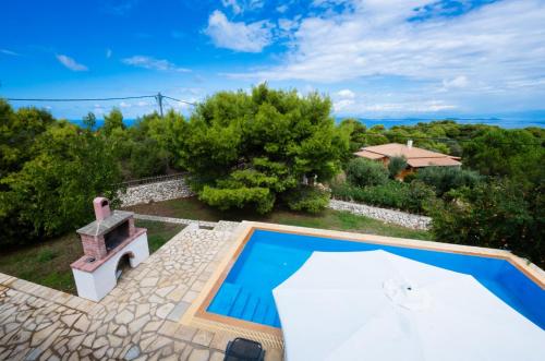 an external view of a villa with a swimming pool at Villa Eudora in Tsoukaladhes