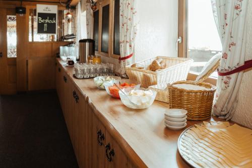 a kitchen counter with baskets of food on it at Berggasthof Hörnerhaus in Bolsterlang