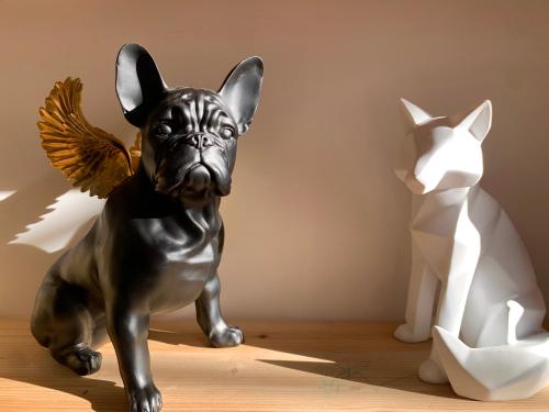 a small statue of a dog with an angel on it at Les Fabuleux appartements du Coeur de ville - Place Victor Hugo in Besançon