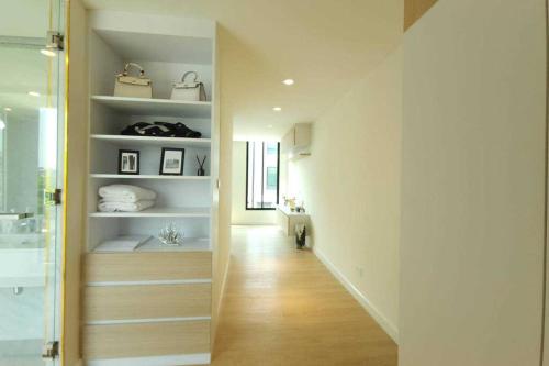 a hallway leading to a bathroom with a sink at The Pearl Residence House-At least 2 months in Bang O