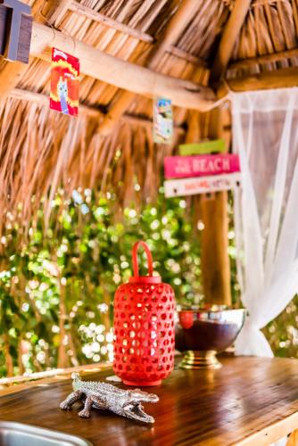 a red candle sitting on top of a wooden table at Villa Nautilus in Tamarindo