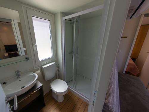a bathroom with a shower and a toilet and a sink at Adria Family Zone B 61 in Klenovica