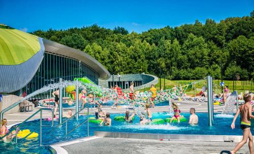 a group of people in a pool at a water park at Apartamenty RETRO FV in Koszalin