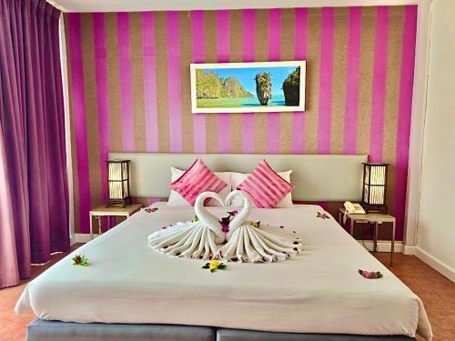 a large bed with a heart made out of pillows at ON Hotel Phuket - SHA in Karon Beach