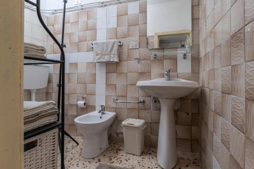 a bathroom with a sink and a toilet at Casa della nonna in Sperlinga