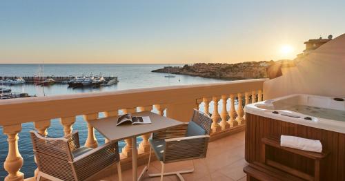 a balcony with a table and a view of the ocean at Pure Salt Port Adriano - Adults Only in Santa Ponsa