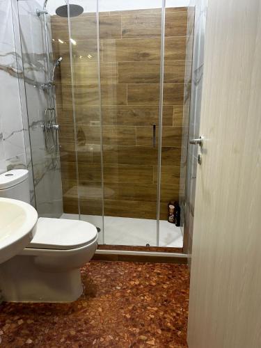 a bathroom with a shower with a toilet and a sink at BAM BAM TIBURTINA Guesthouse in Rome