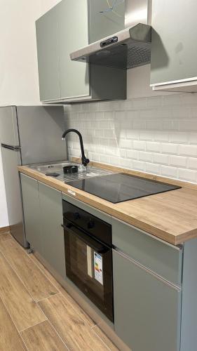 a kitchen with a sink and a stove top oven at BAM BAM TIBURTINA Guesthouse in Rome