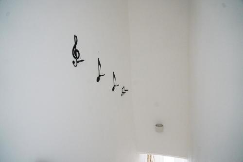 a group of musical notes on a white wall at Wanderlust in Sannicandro di Bari