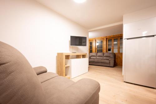 a living room with a couch and a refrigerator at Cesa Meida 2A in Pozza di Fassa