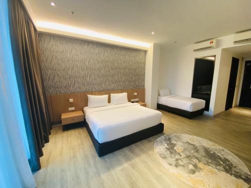 a bedroom with a large white bed and a table at Corner Club Penang in George Town
