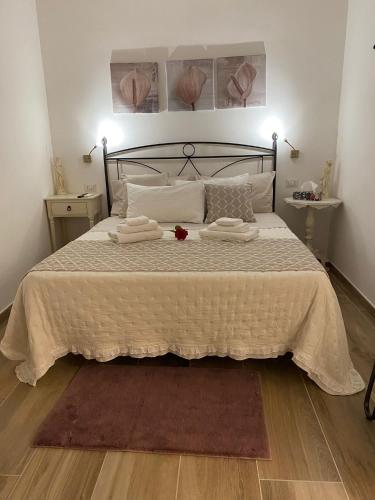 a bedroom with a bed with two towels on it at Le Dimore del Portico in Fasano