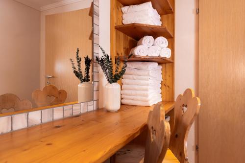 a bathroom with a counter with towels and a mirror at Gästehaus Pilz Schladming in Schladming