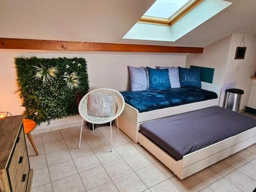 a bedroom with a bed and a table and a plant at Thonon plage terrasse et parking in Thonon-les-Bains
