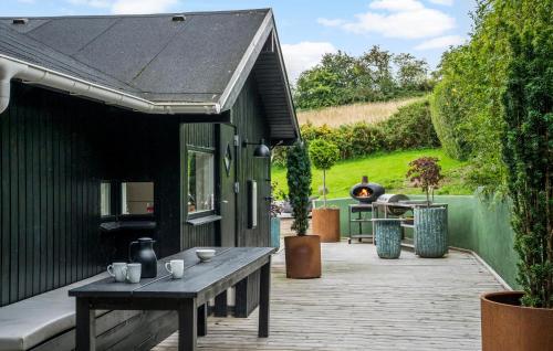 a patio with a wooden table and a house at Beautiful Home In Kolding With Wifi in Kolding