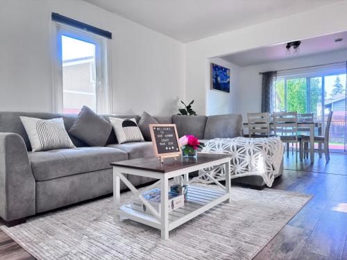 a living room with a couch and a table at Cozy Stay Retreat in Fairbanks