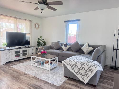 a living room with a couch and a flat screen tv at Cozy Stay Retreat in Fairbanks