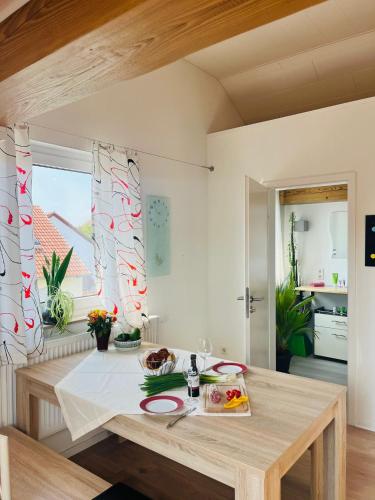 a dining room with a wooden table and a dining room at Appartments - Stromberg & Zabergäu in Erligheim