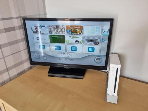 a tv sitting on a table with a wii remote at The Humsford Hideaway 2 bedroom home with driveway in Cramlington