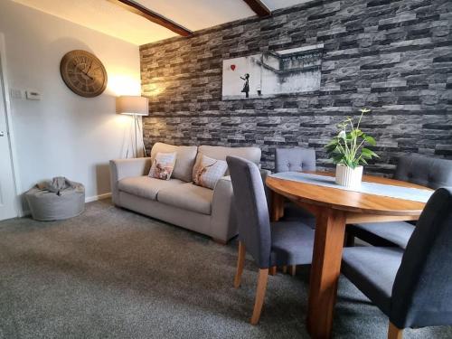 a living room with a couch and a table at The Humsford Hideaway 2 bedroom home with driveway in Cramlington