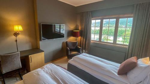 a hotel room with a bed and a television at Trysil-Knut Hotel in Trysil