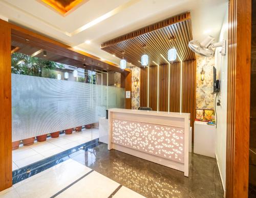 a lobby with a reception desk and a swimming pool at Treebo Lotus Blue in Bhopal
